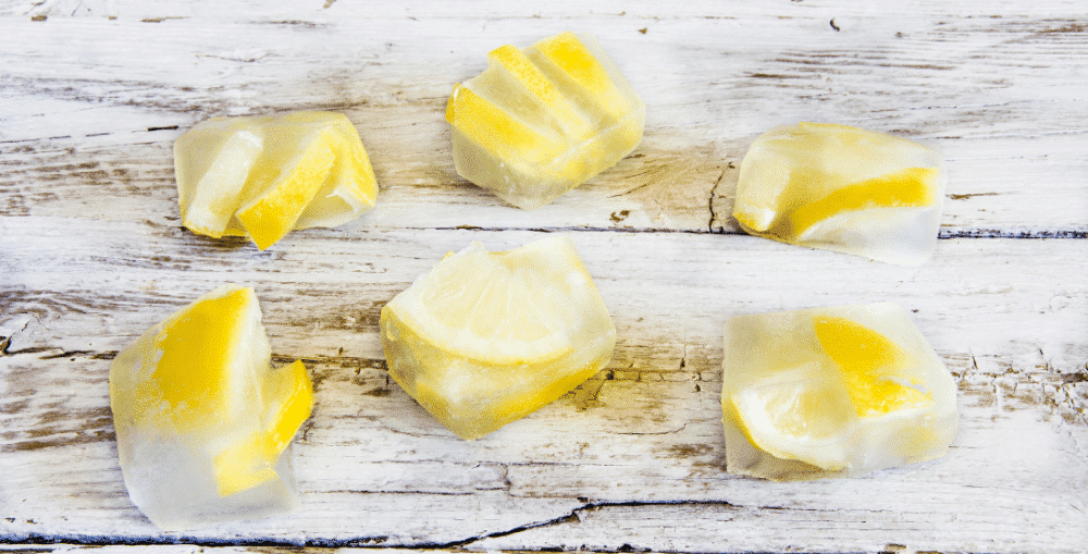 Lemon slices frozen in ice cubes. Refreshing summer drink idea using ice cube trays.