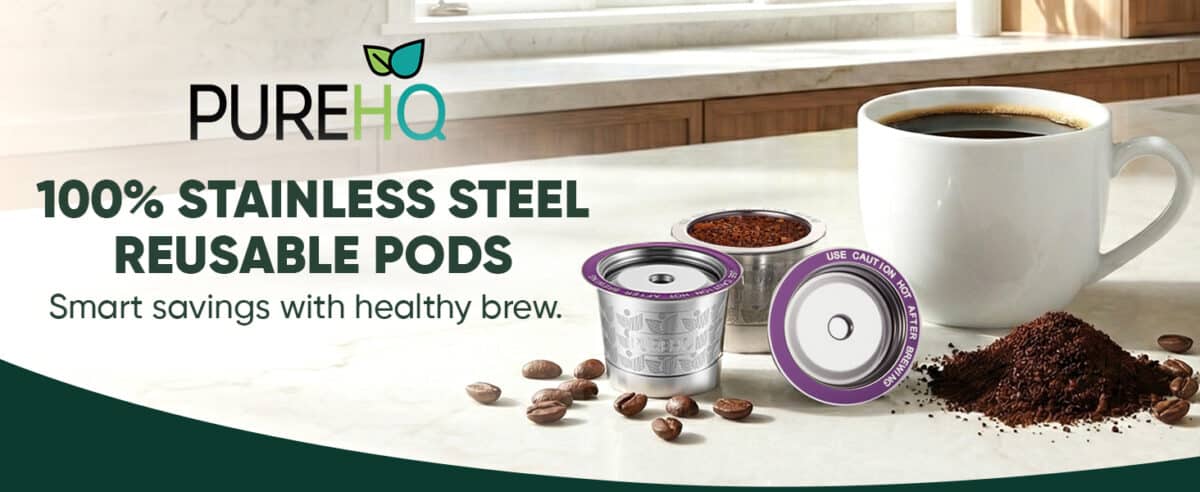 Two PureHQ stainless steel reusable K cups with coffee grounds next to a mug of coffee.