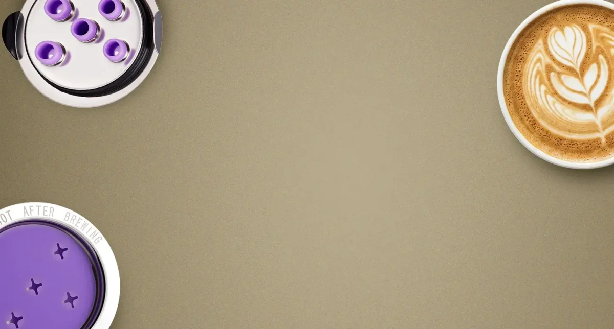 Overhead view of reusable K-Cups, Keurig water filters, and a latte. Home coffee brewing setup.