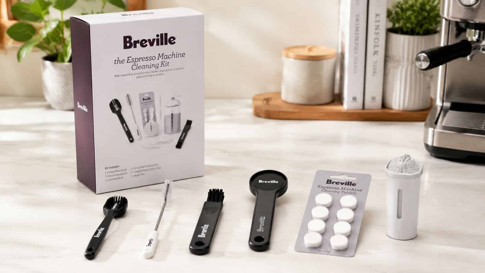 A Breville espresso machine cleaning kit box with brushes, cleaning tablets, and a water filter on a counter.