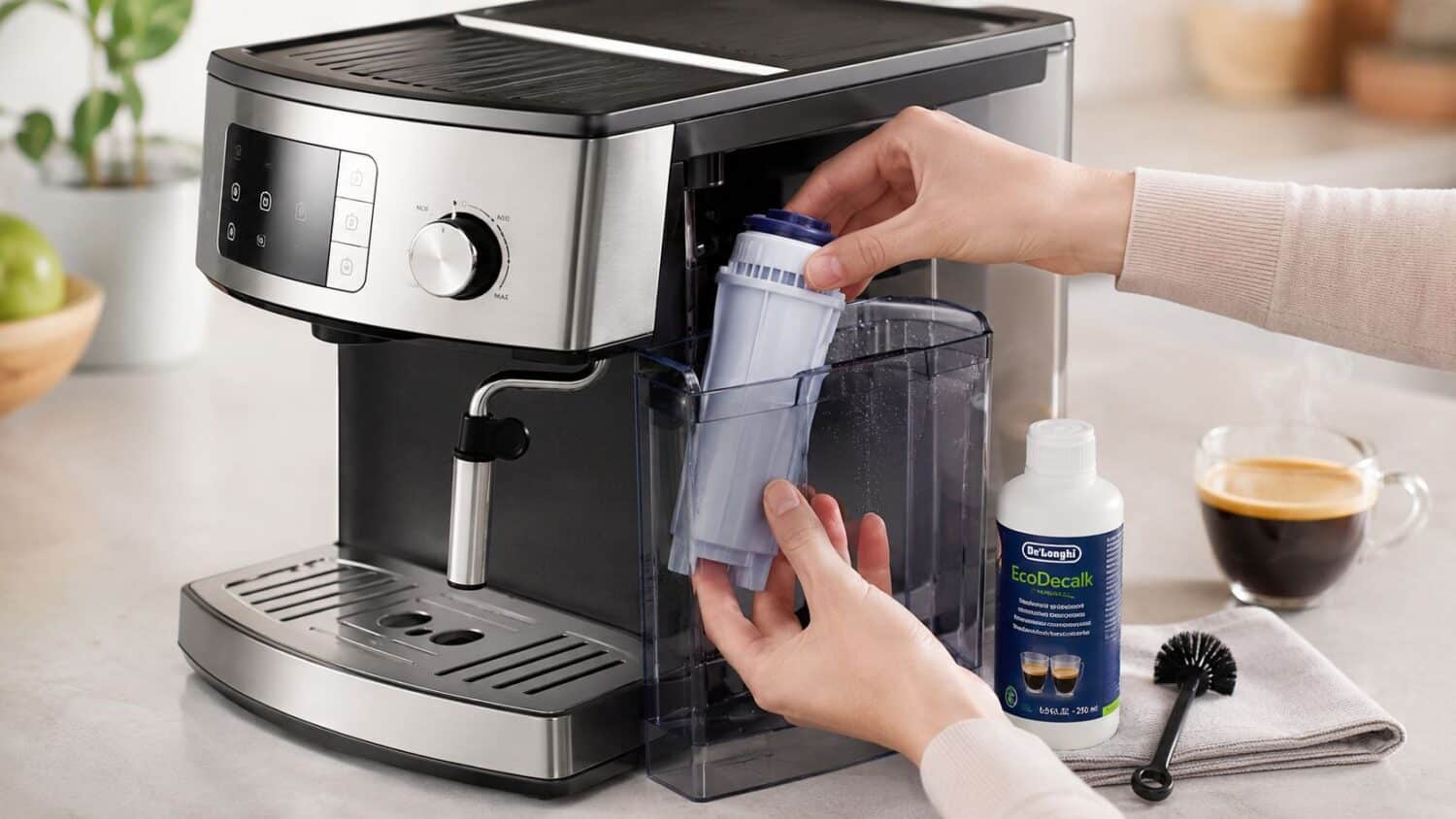 Person inserting water filter into De'Longhi coffee machine, EcoDecalk bottle nearby
