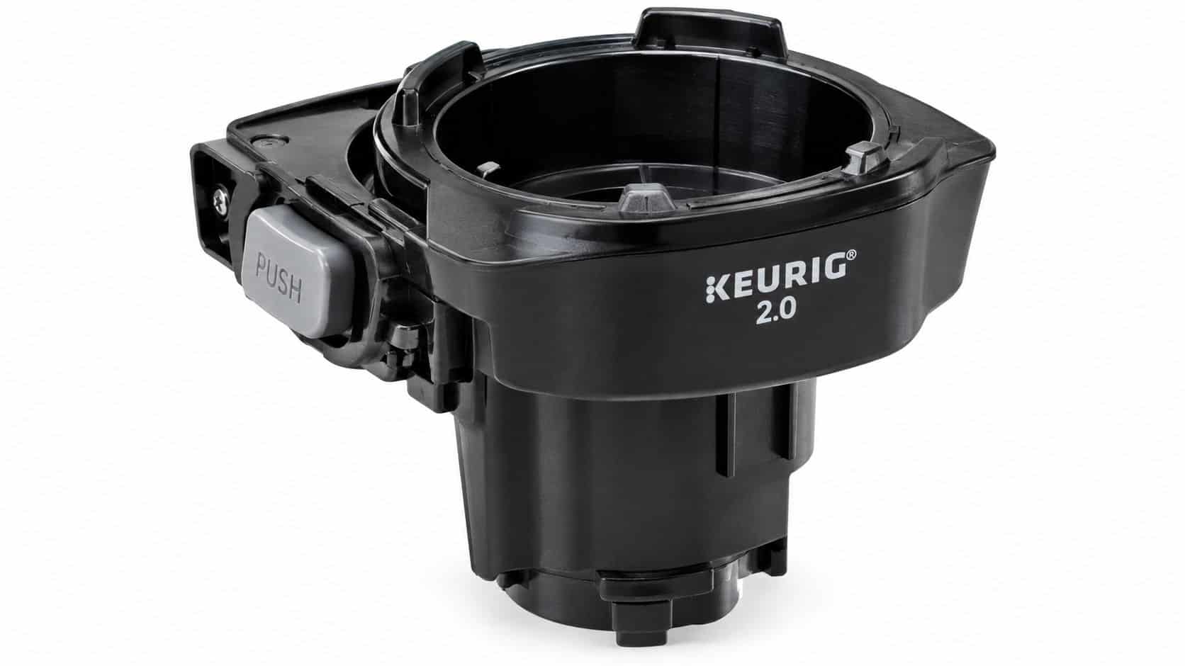 A black plastic Keurig 2.0 K-Cup holder assembly featuring a grey push button on the side.